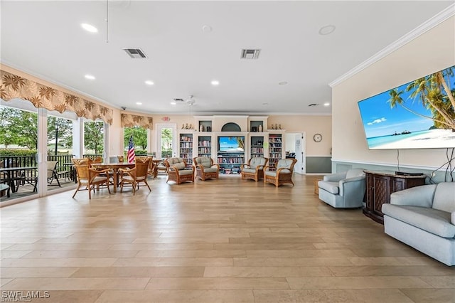 living room featuring crown molding and light hardwood / wood-style floors