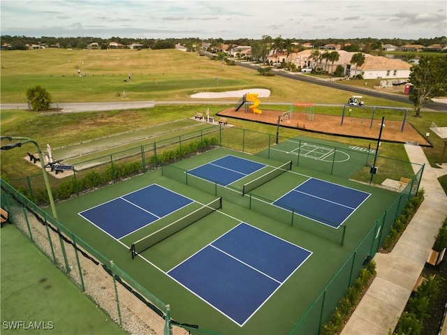 view of tennis court featuring basketball hoop