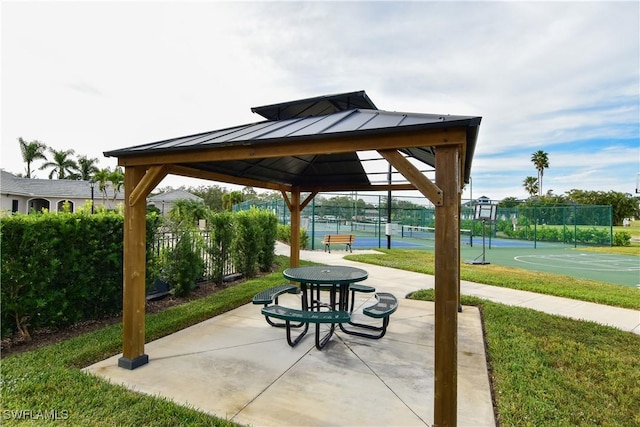 view of property's community with a gazebo, tennis court, and basketball hoop