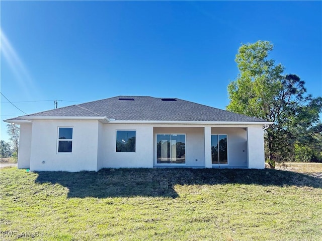 back of property featuring a lawn