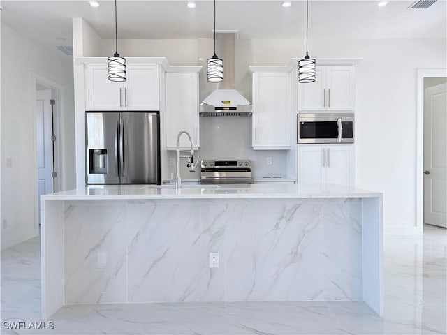 kitchen with pendant lighting, stainless steel appliances, white cabinetry, and a center island with sink