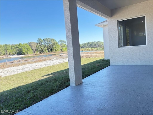 view of patio with a water view