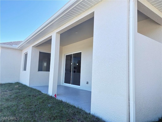 view of side of home featuring a patio area