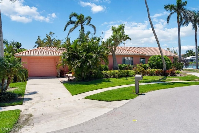 ranch-style house featuring a front yard and a garage