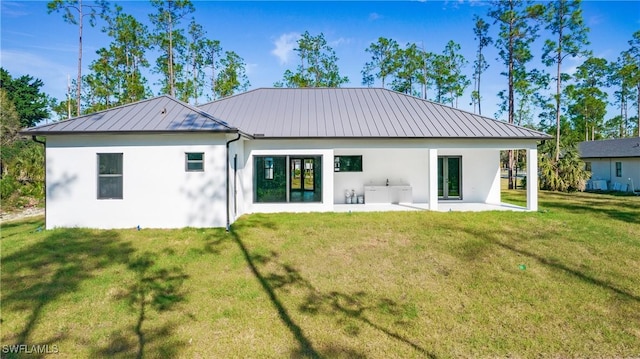 back of house featuring a patio area and a yard