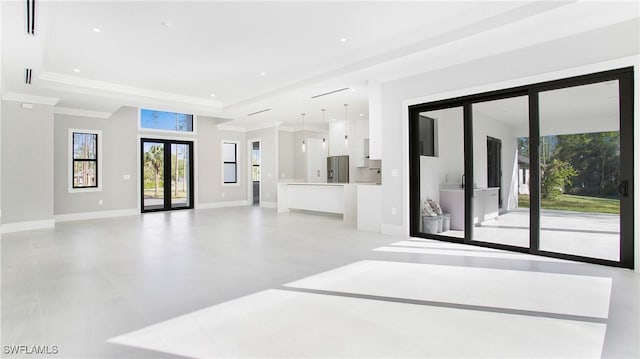 living room with a raised ceiling, crown molding, and french doors