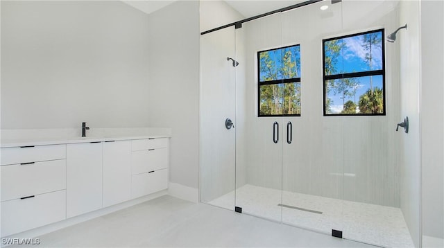 bathroom with vanity, an enclosed shower, and concrete flooring