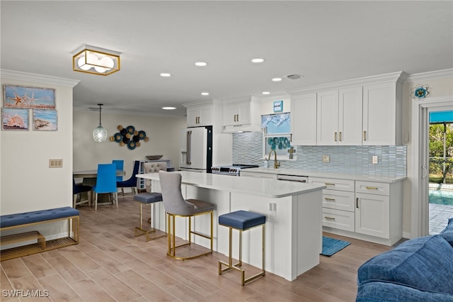 kitchen with white cabinetry, light wood-type flooring, white appliances, and ornamental molding