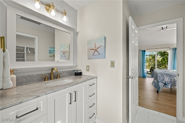 bathroom with ceiling fan, hardwood / wood-style floors, and vanity