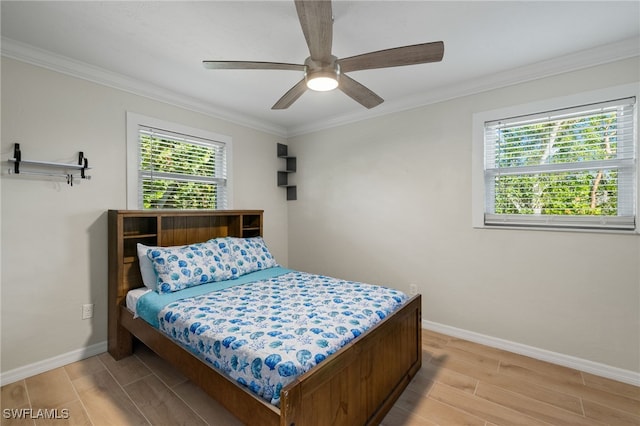 bedroom featuring multiple windows, ceiling fan, light hardwood / wood-style flooring, and ornamental molding