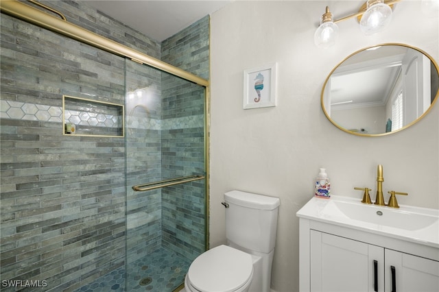 bathroom featuring a shower with door, vanity, and toilet