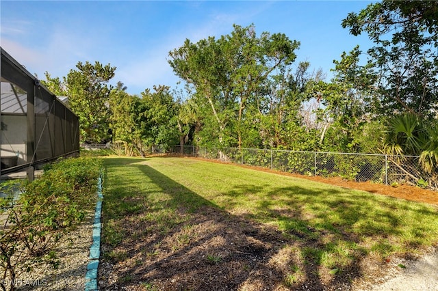 view of yard featuring glass enclosure