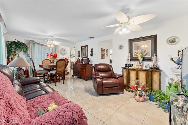 tiled living room with ceiling fan