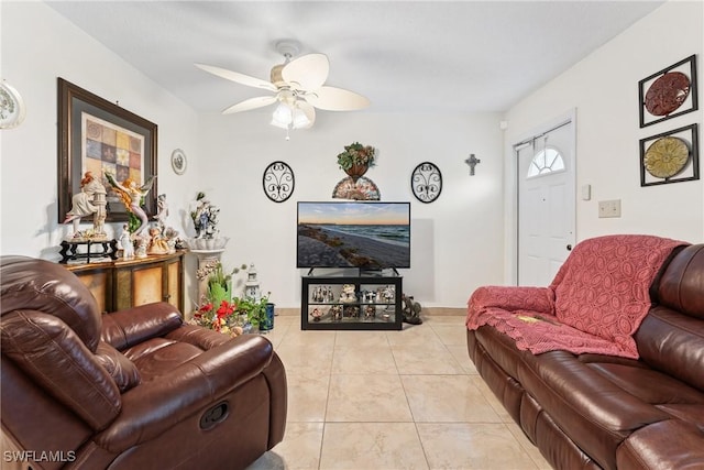 tiled living room with ceiling fan