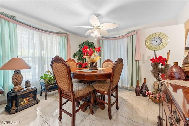 dining room featuring light tile patterned floors and ceiling fan