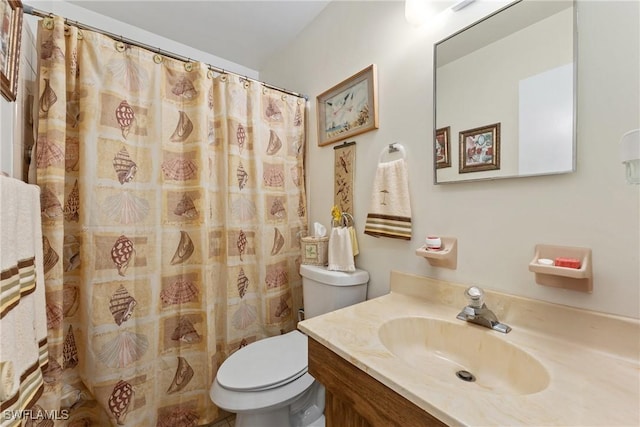 bathroom with a shower with curtain, vanity, and toilet