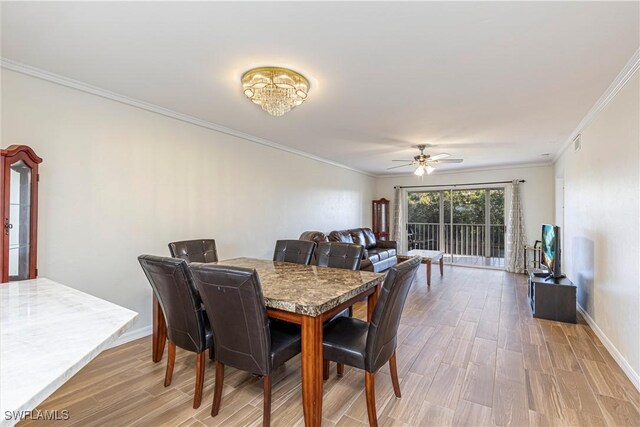 dining space featuring wood-type flooring, ceiling fan with notable chandelier, and ornamental molding