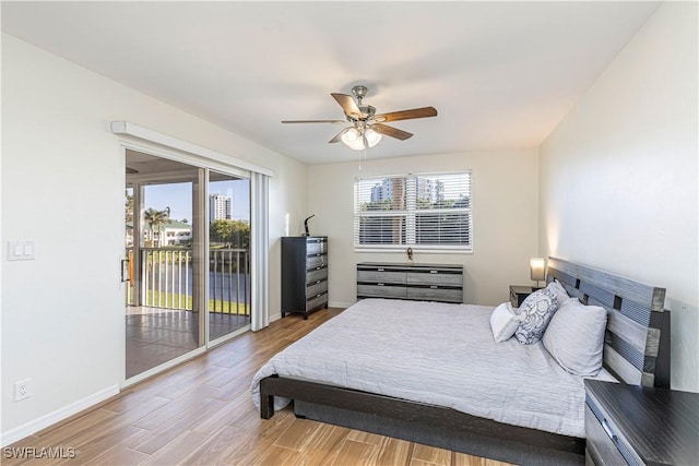 bedroom with hardwood / wood-style floors, access to outside, and ceiling fan