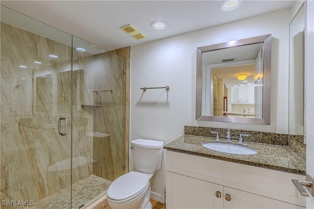 bathroom with vanity, toilet, and walk in shower