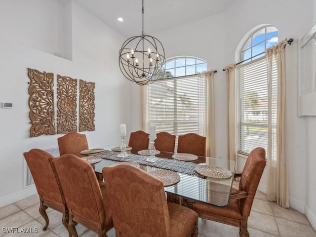 tiled dining room featuring high vaulted ceiling and an inviting chandelier