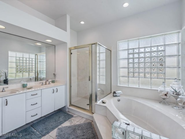 bathroom with tile patterned floors, vanity, and independent shower and bath