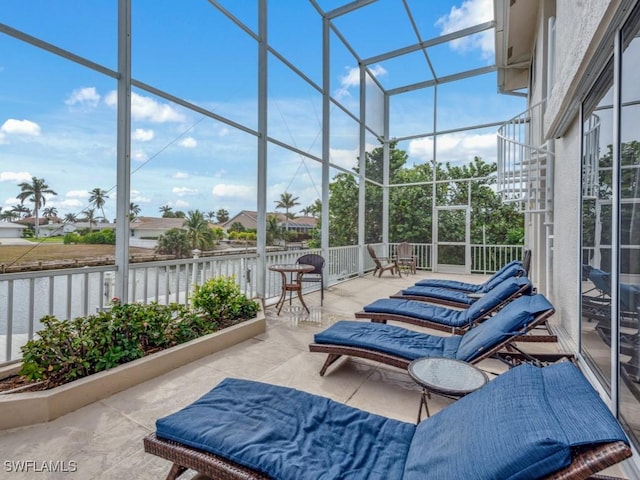 sunroom with a water view and a healthy amount of sunlight