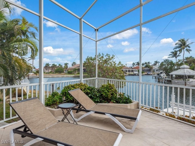 unfurnished sunroom featuring a water view