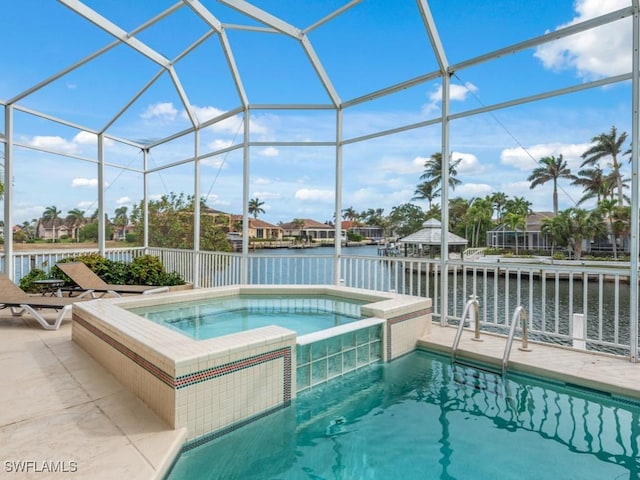 view of pool with a lanai, a water view, and an in ground hot tub