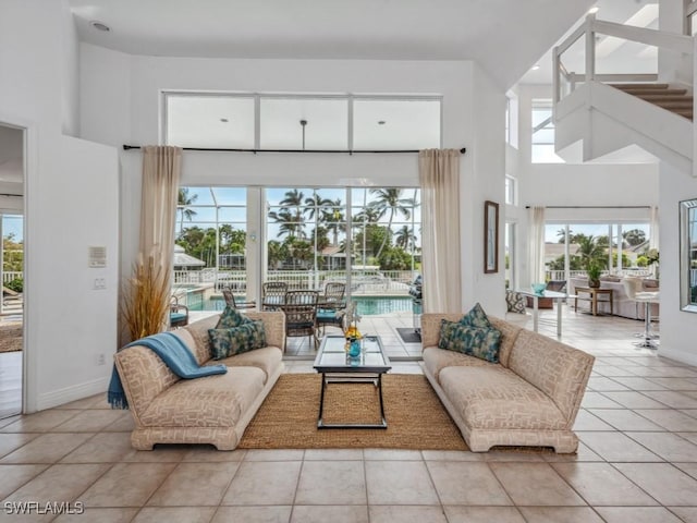 tiled living room with a towering ceiling