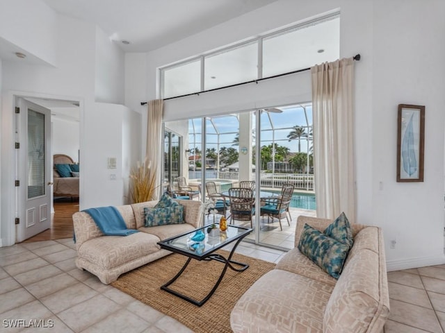 tiled living room featuring a high ceiling