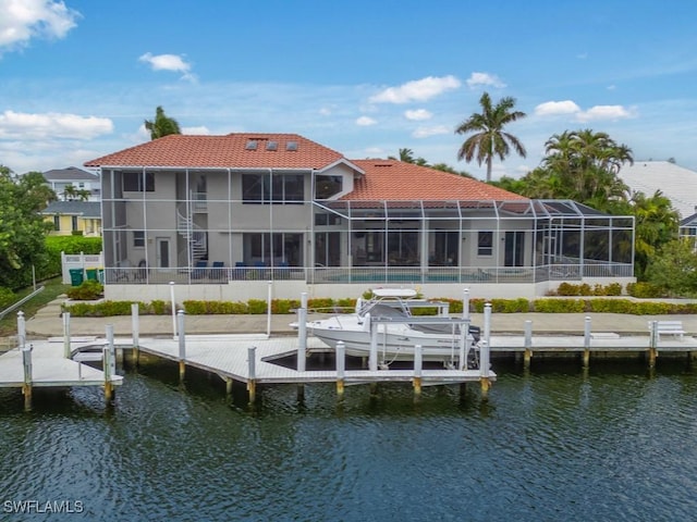 back of property featuring a lanai and a water view