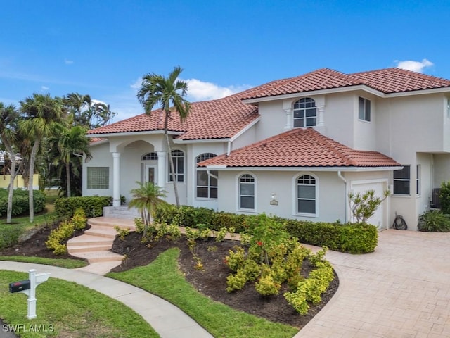 mediterranean / spanish-style home featuring a garage