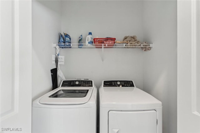 clothes washing area with separate washer and dryer