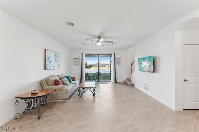 tiled living room with ceiling fan