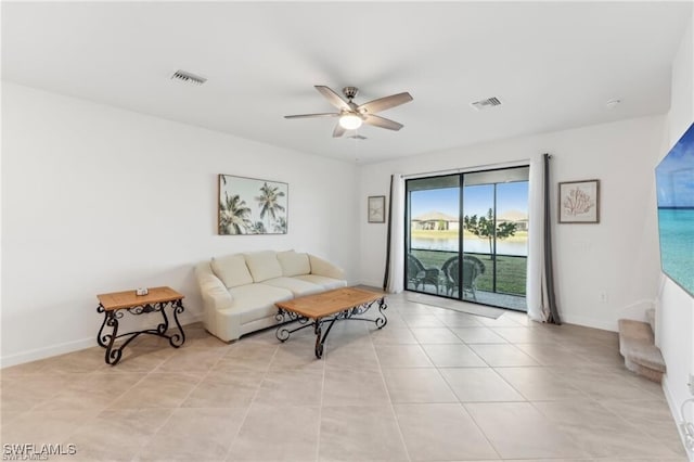 tiled living room with ceiling fan