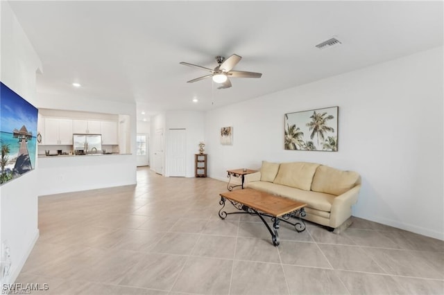 living room featuring ceiling fan and light tile patterned floors