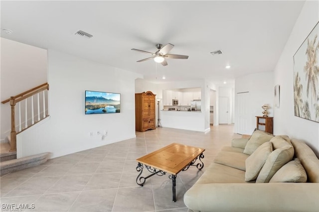 living room featuring ceiling fan and light tile patterned floors