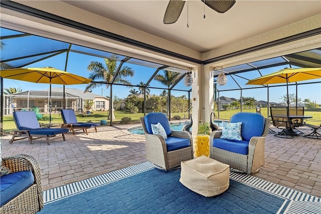 view of patio / terrace featuring glass enclosure and ceiling fan