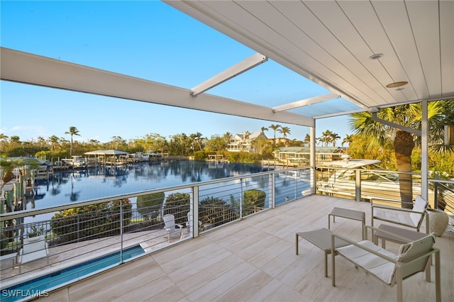 wooden terrace featuring a water view