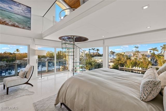 bedroom featuring access to exterior, a water view, and light tile patterned floors