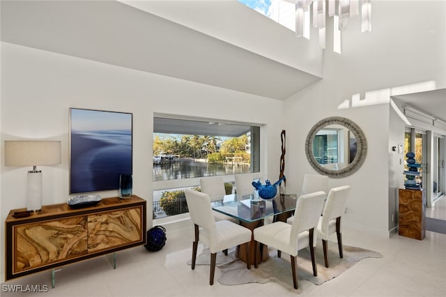 tiled dining space featuring a water view