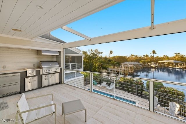 wooden terrace featuring area for grilling, a sunroom, and a water view