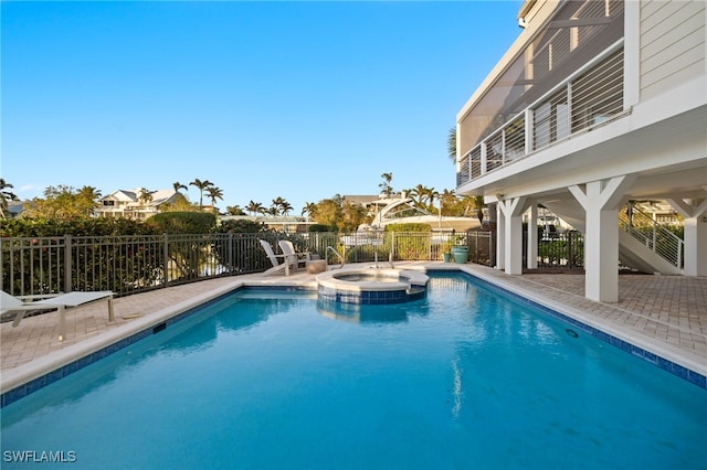 view of swimming pool with an in ground hot tub and a patio area