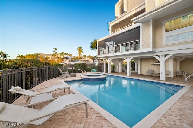 view of pool with an in ground hot tub and a patio area