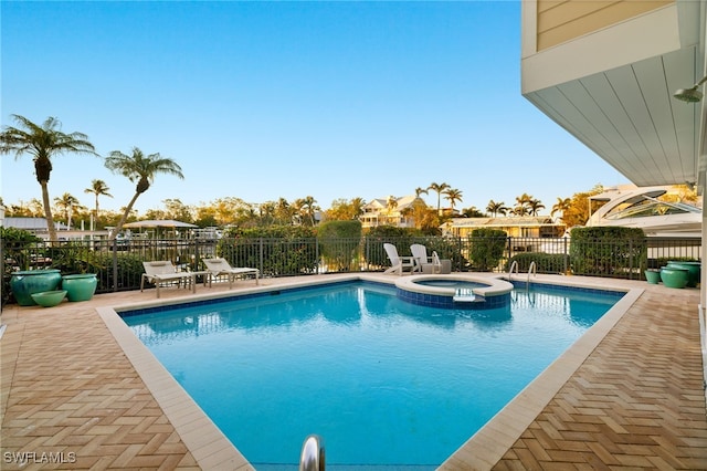 view of pool with an in ground hot tub and a patio area