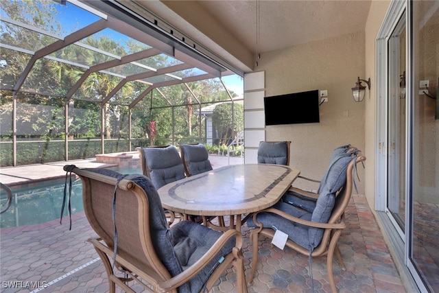 view of patio with an outdoor pool, a lanai, a jacuzzi, and outdoor dining area