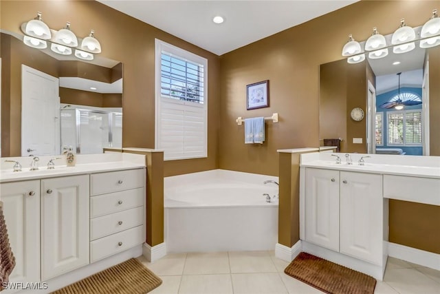 bathroom with two vanities, a sink, a shower stall, tile patterned flooring, and a bath