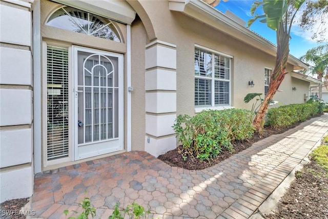 property entrance featuring stucco siding