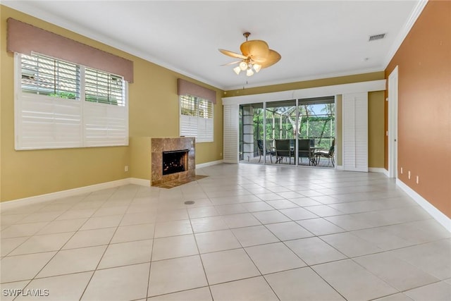 unfurnished living room featuring a high end fireplace, plenty of natural light, visible vents, and crown molding