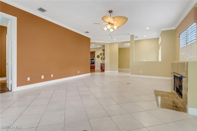 unfurnished living room with a fireplace, crown molding, visible vents, and light tile patterned flooring